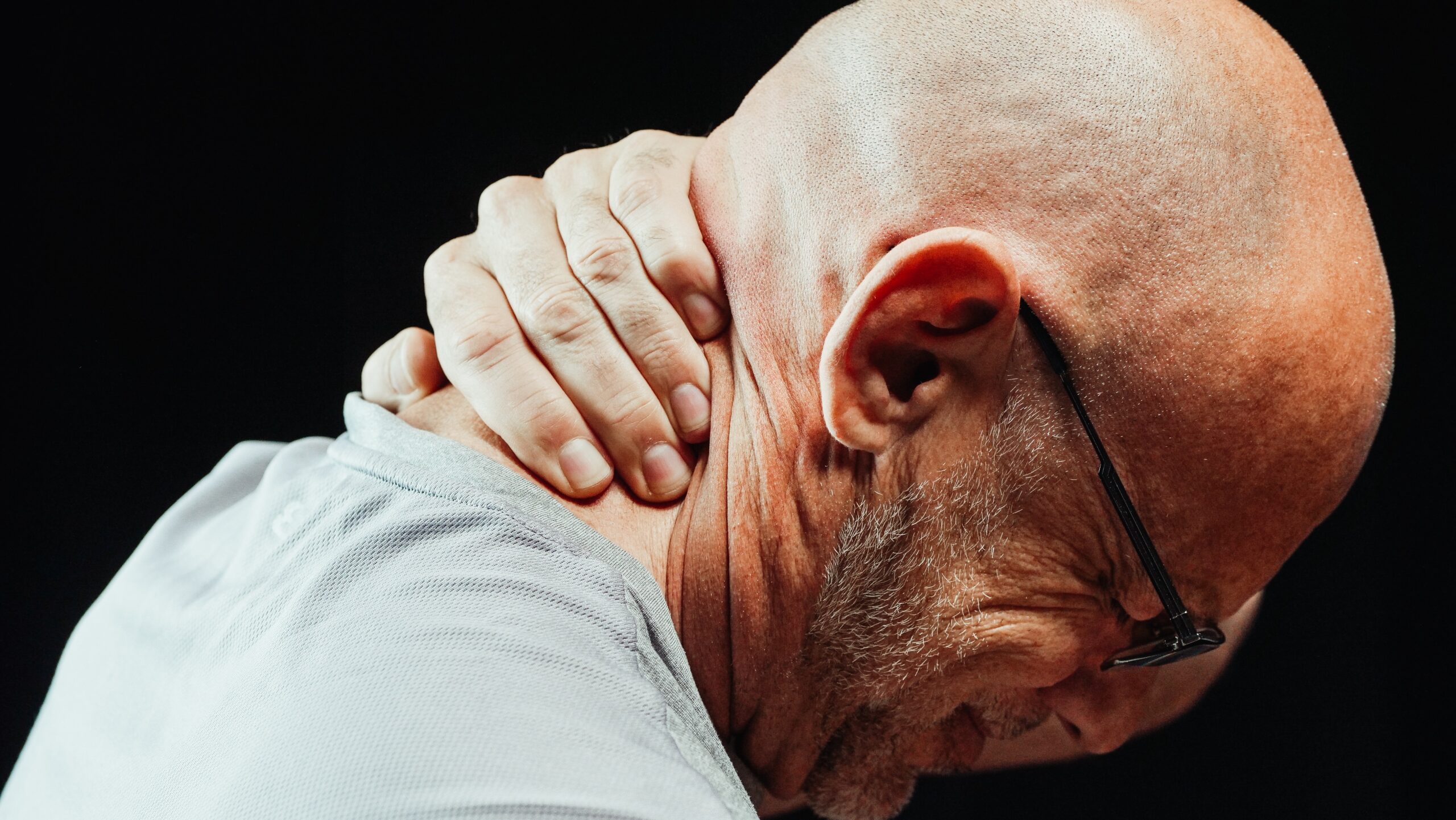 man holding his neck